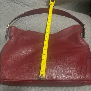 Beautiful maroon purse in great condition. A bit of wear on the strap.
